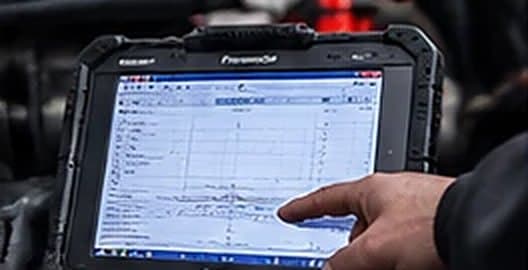 Before-and-after diagnostic readings shown on a rugged tablet